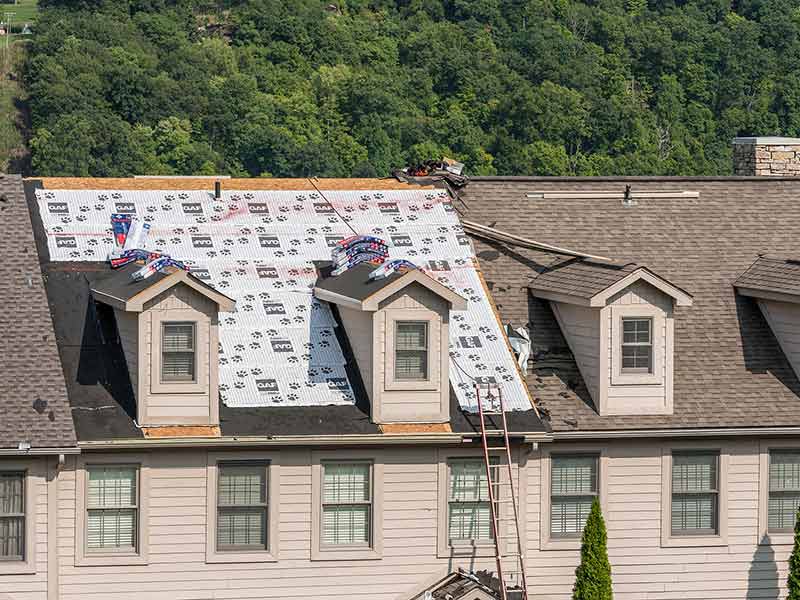 Close up of a residential roof getting its shingles replaced with GAF shingles
