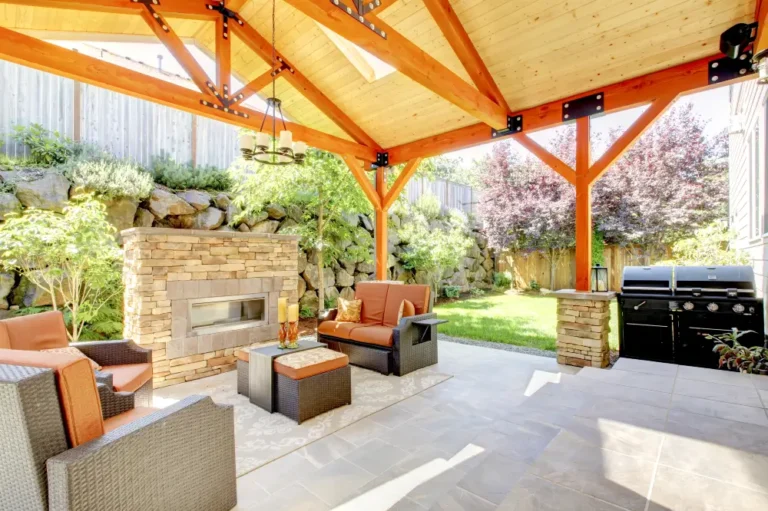Exterior covered patio with fireplace and furniture - Dagmar Pros