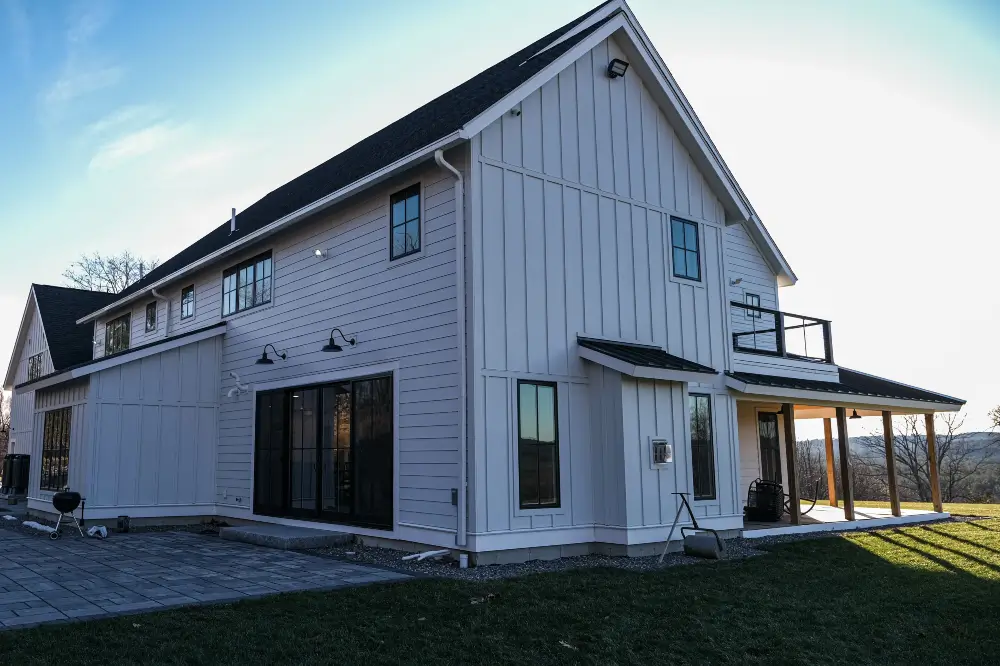 A white two-story house with James Hardie fiber cement siding. If your home needs siding repair services, call Dagmar Construction.