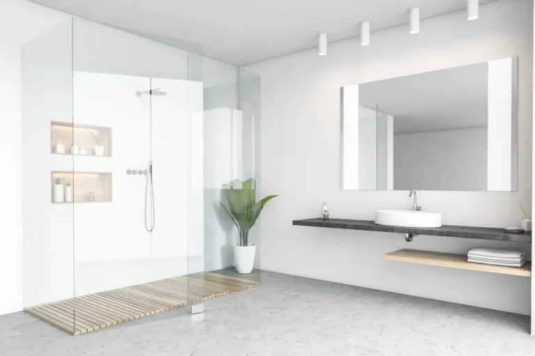 Minimalist gray bathroom with with a glass shower, after bathroom remodeling - Dagmar Pros