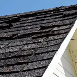 closeup of roof with damaged shingles