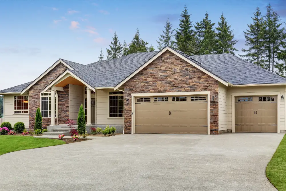 Luxury one level house exterior with brick trim and garage - Dagmar Construction