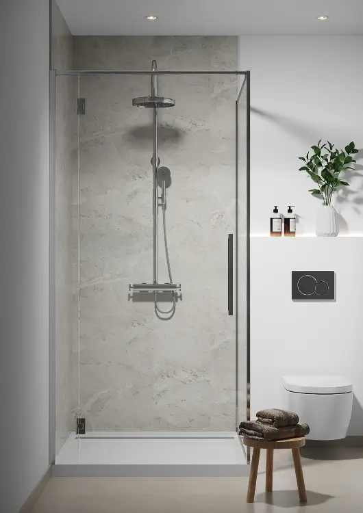 Glass shower enclosure with new white marble tiling, after bathroom remodeling